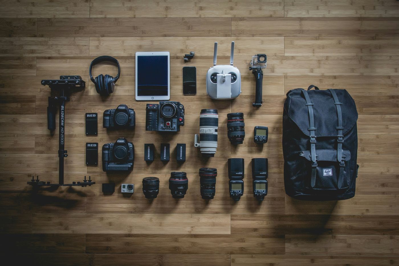 A table with a lot of camera gear laid out neatly and ready to pack