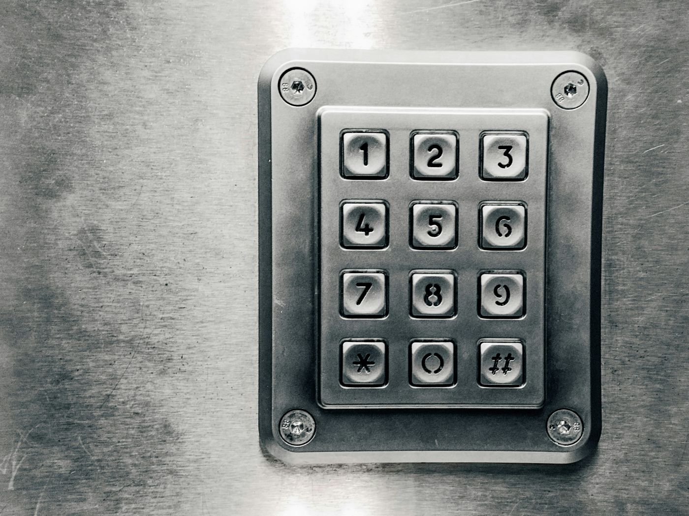 A close up of a metal number keypad