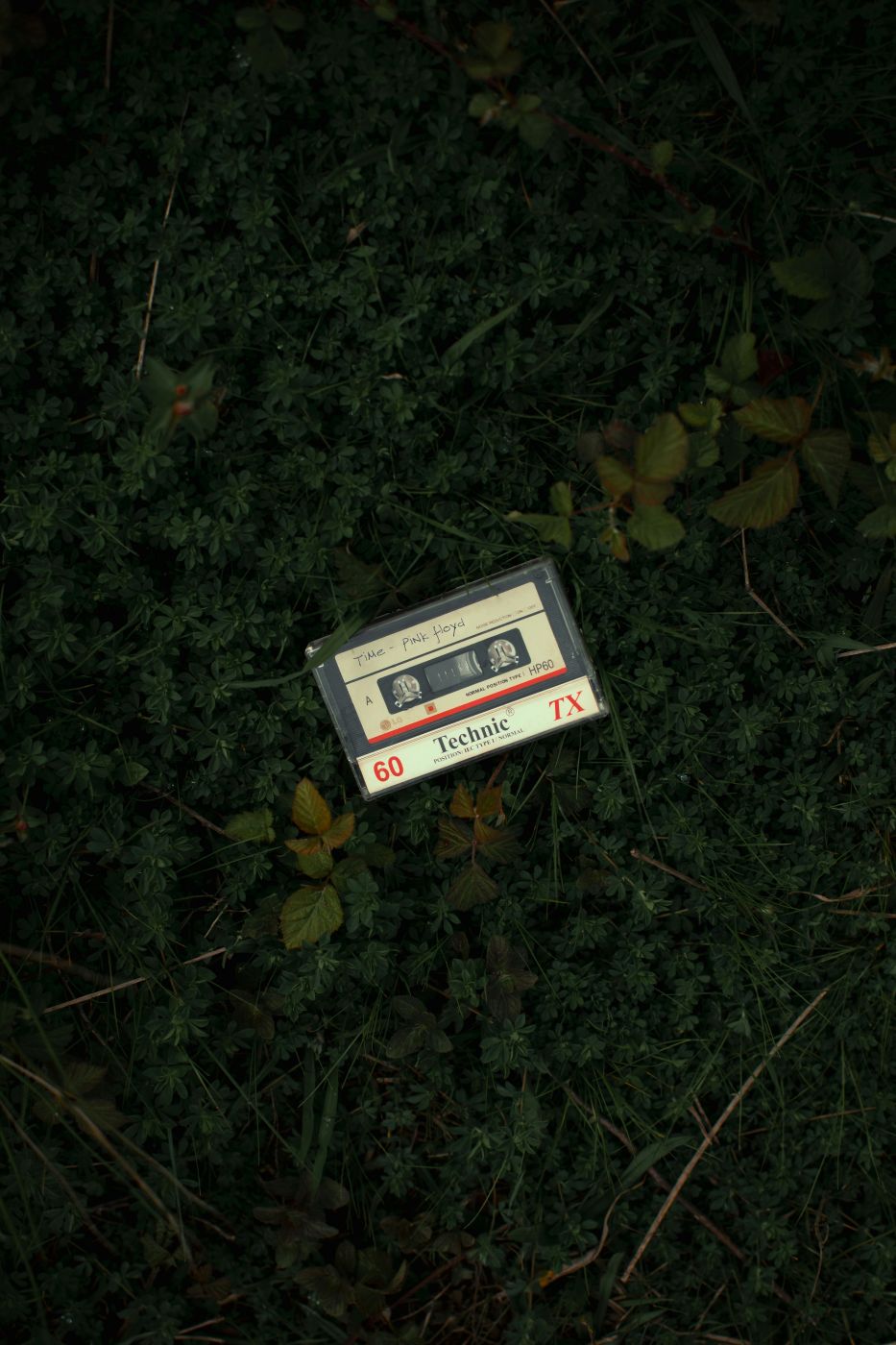 A cassette tape sitting on the ground