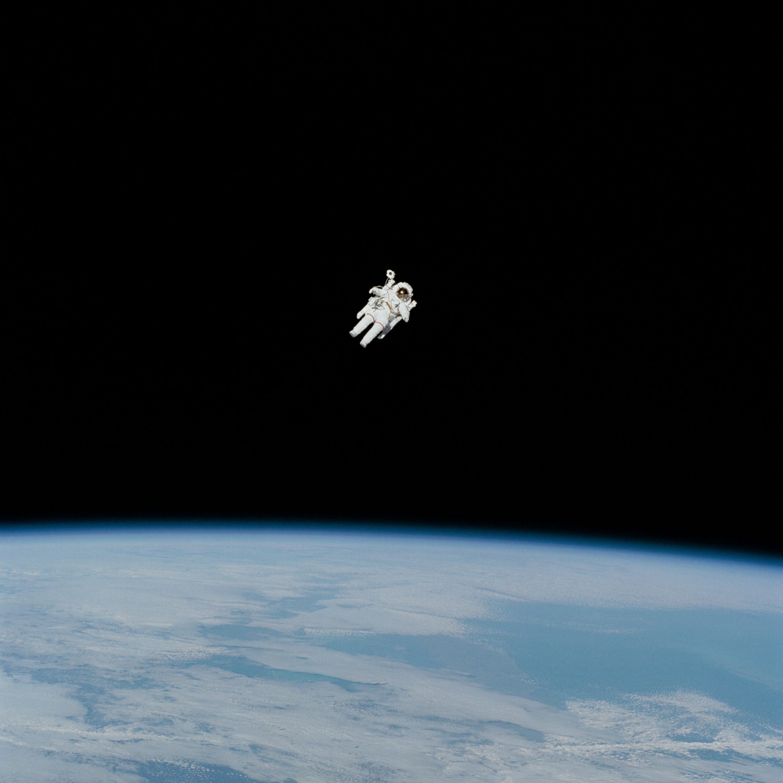 A lobe Astronaut floating in space above the Earth