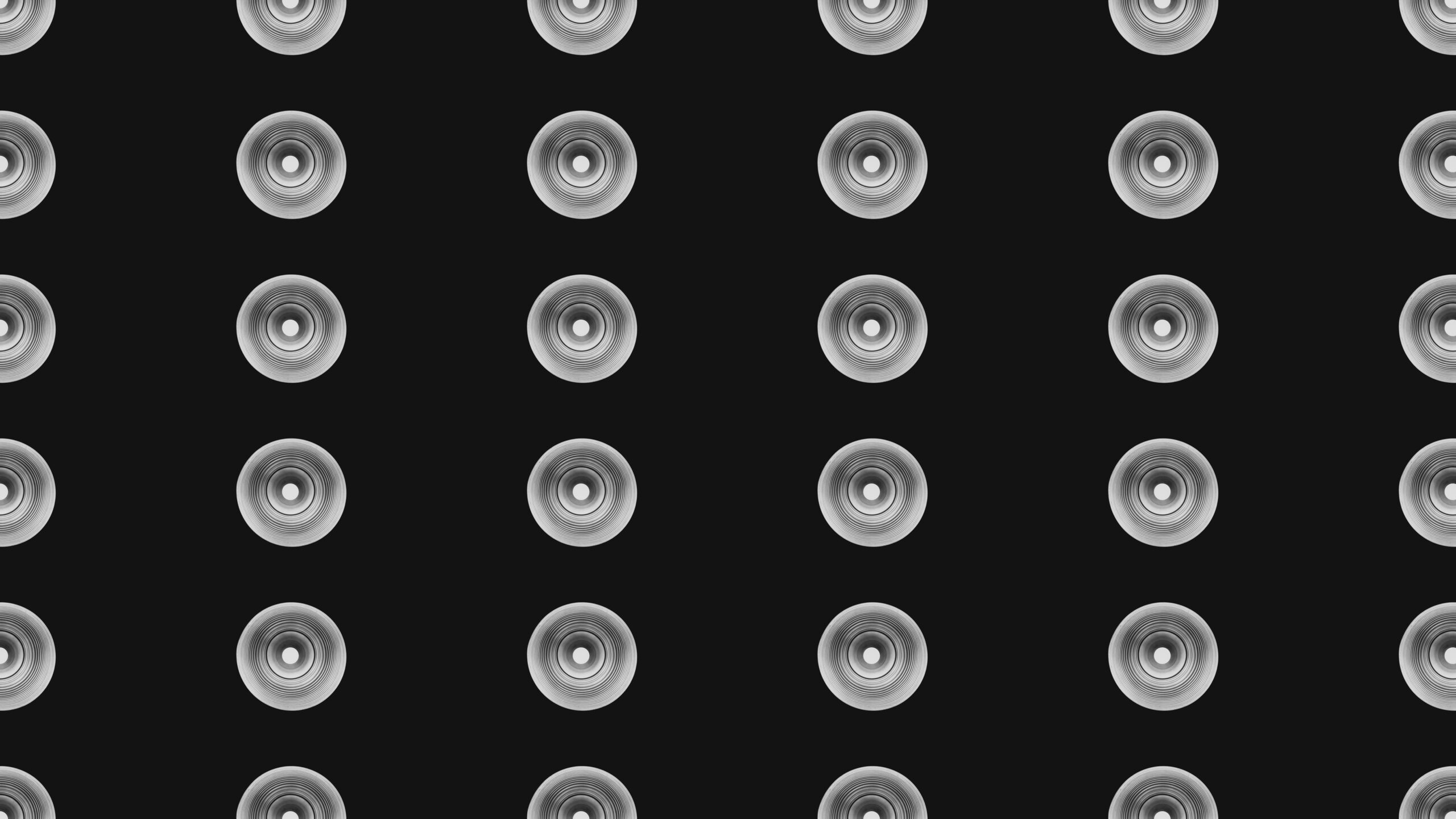 A grid of speakers against a black backdrop