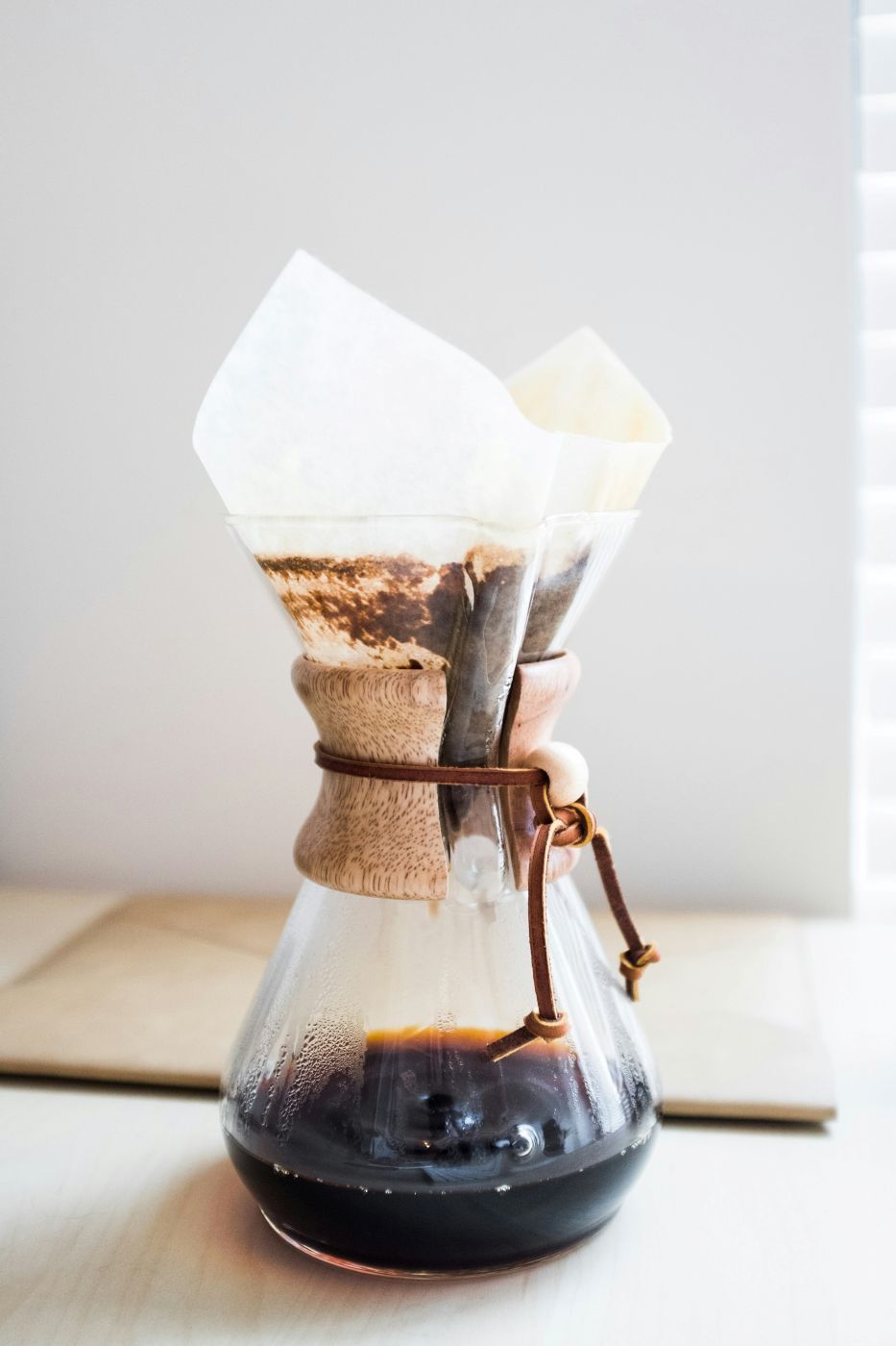 A glass carafe with a coffee filter in it