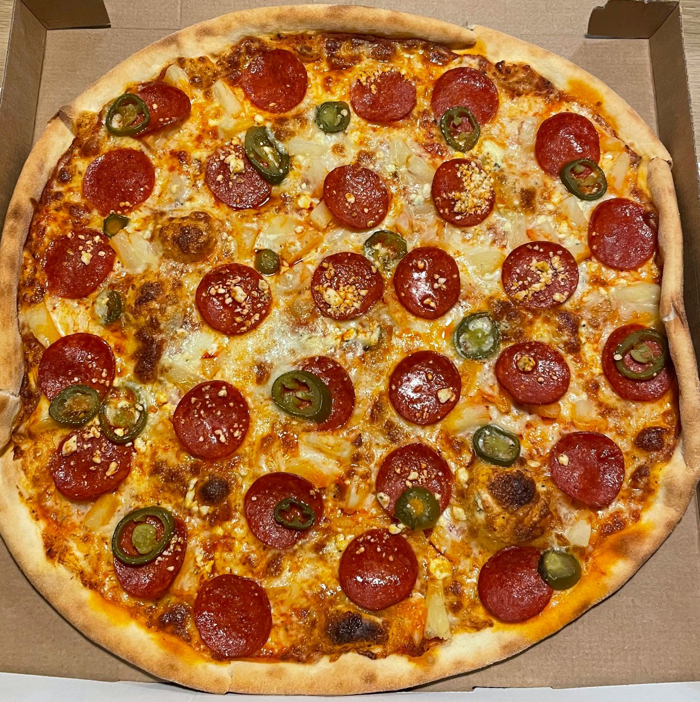 A pepperoni & jalepeno pizza in the box