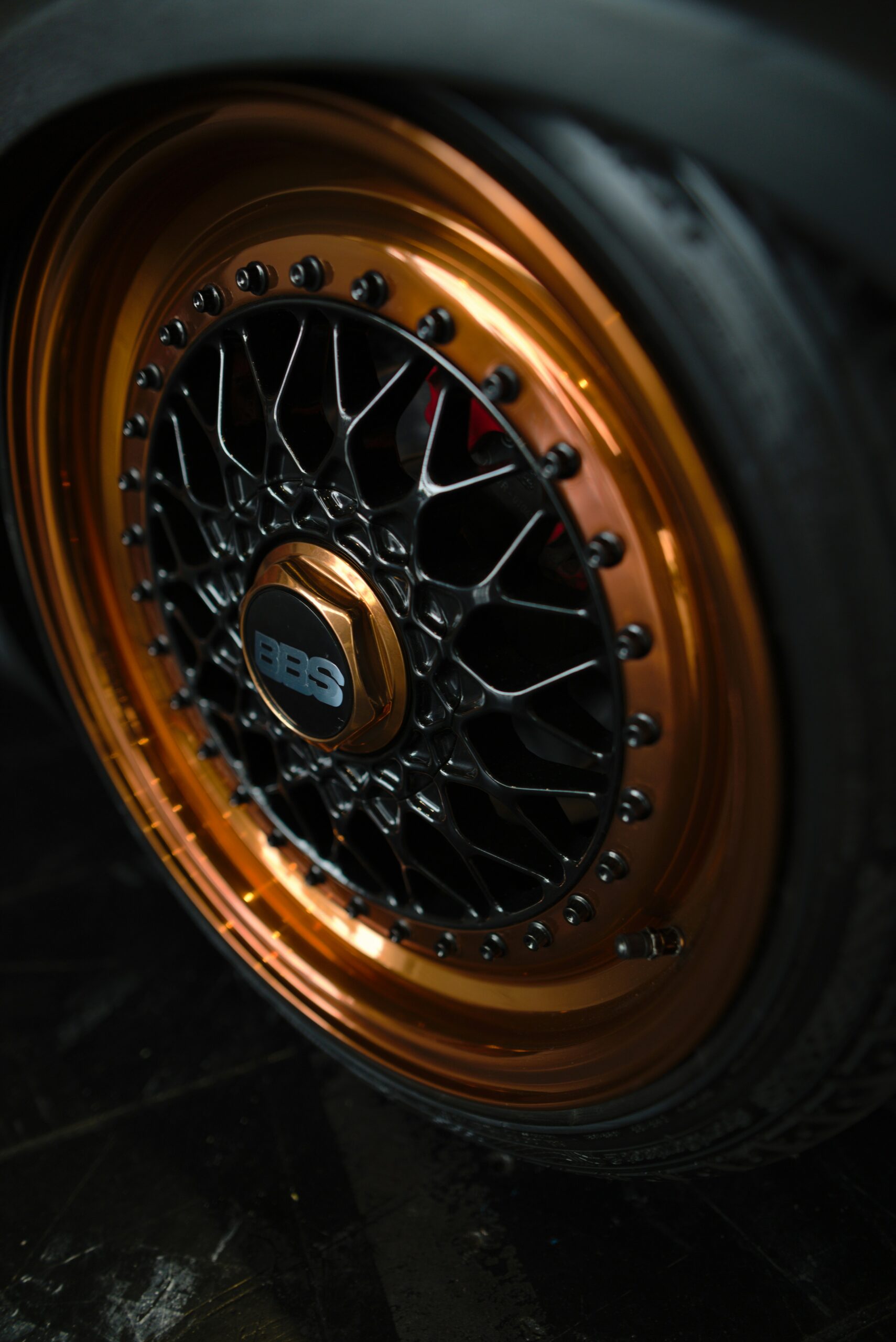 A highly polished copper colored hubcap