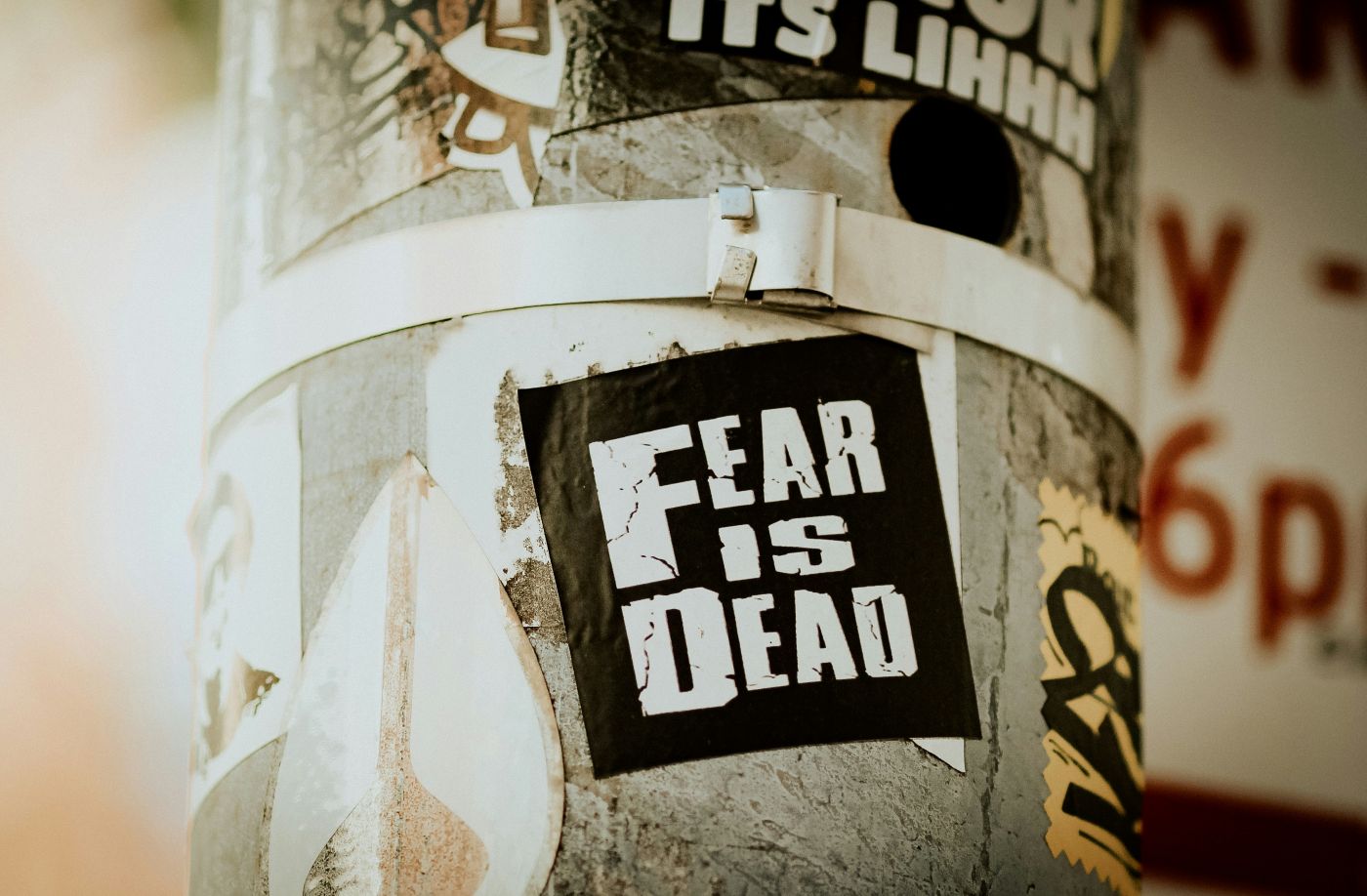 A bill on a light post reads Fear is Dead