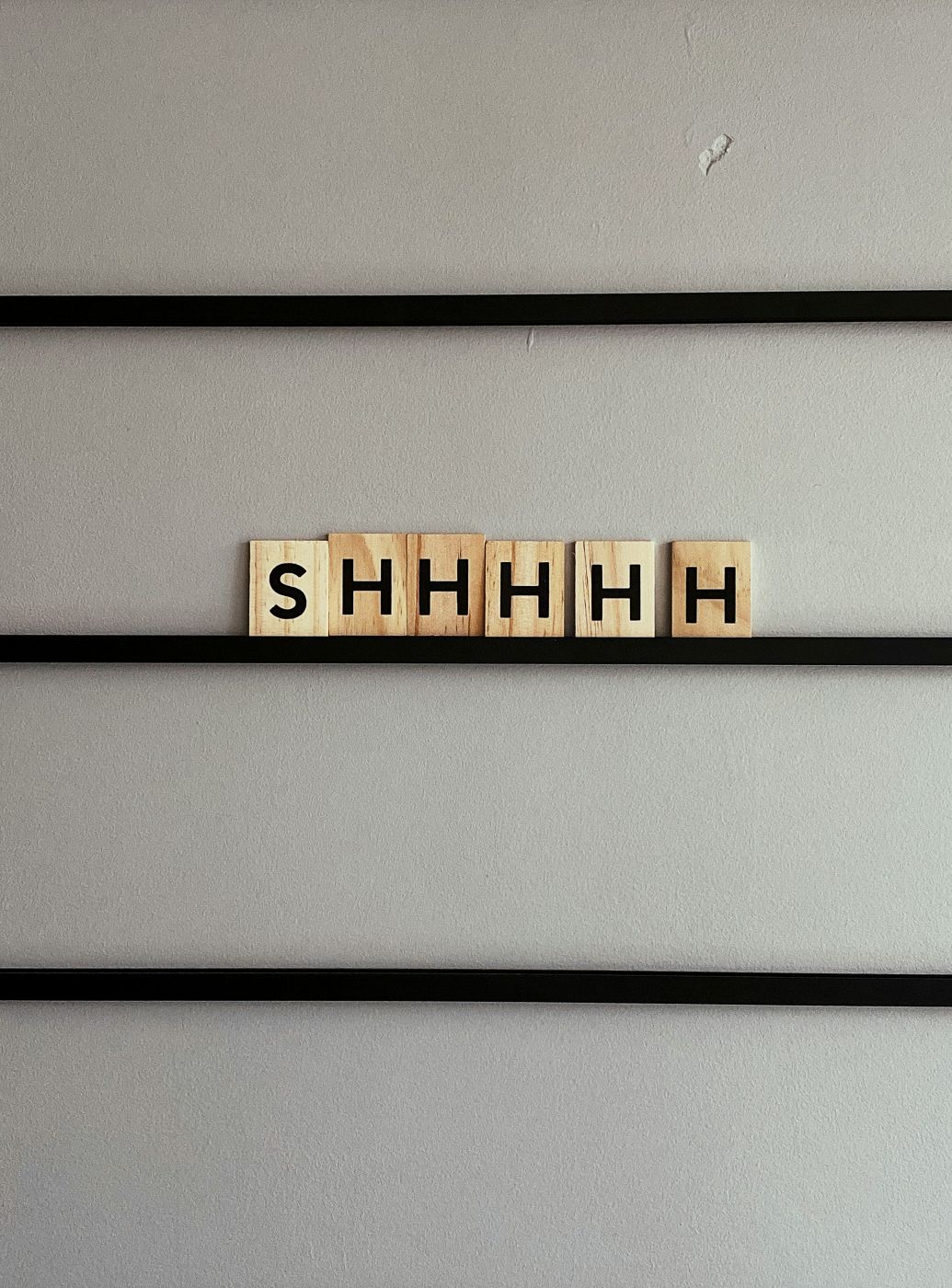 Scrabble tiles spelling out SHHHHH