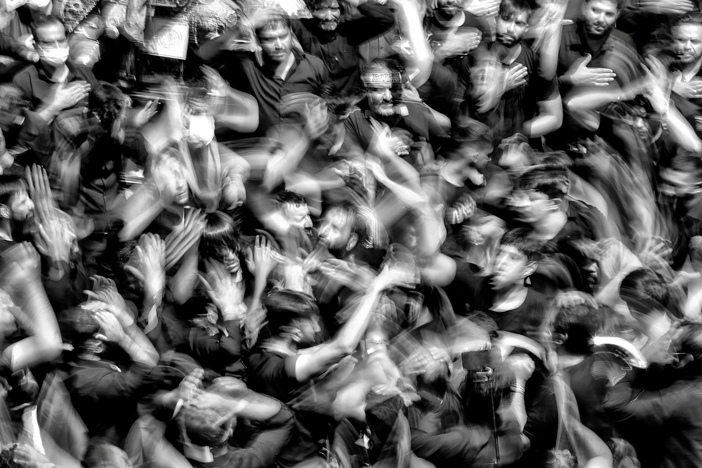 a black and white of a crowd in motion