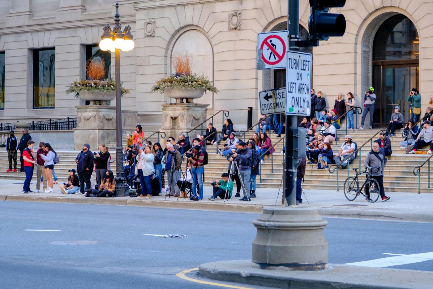 People on a curb with cameras