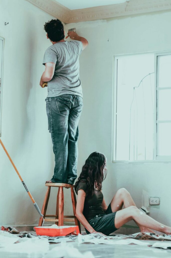 A couple painting the interior of their house