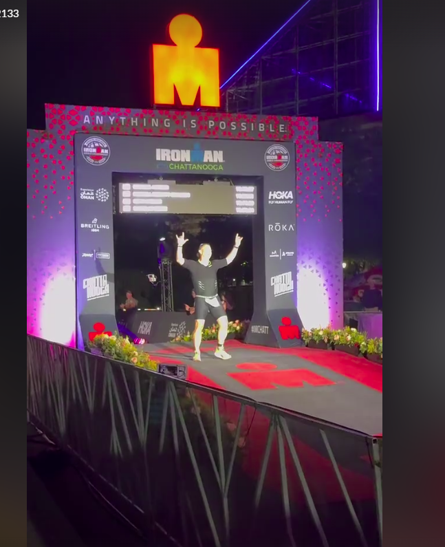 ThoughtLab CEO Mike Harker crossing the finish line at the Ironman competition