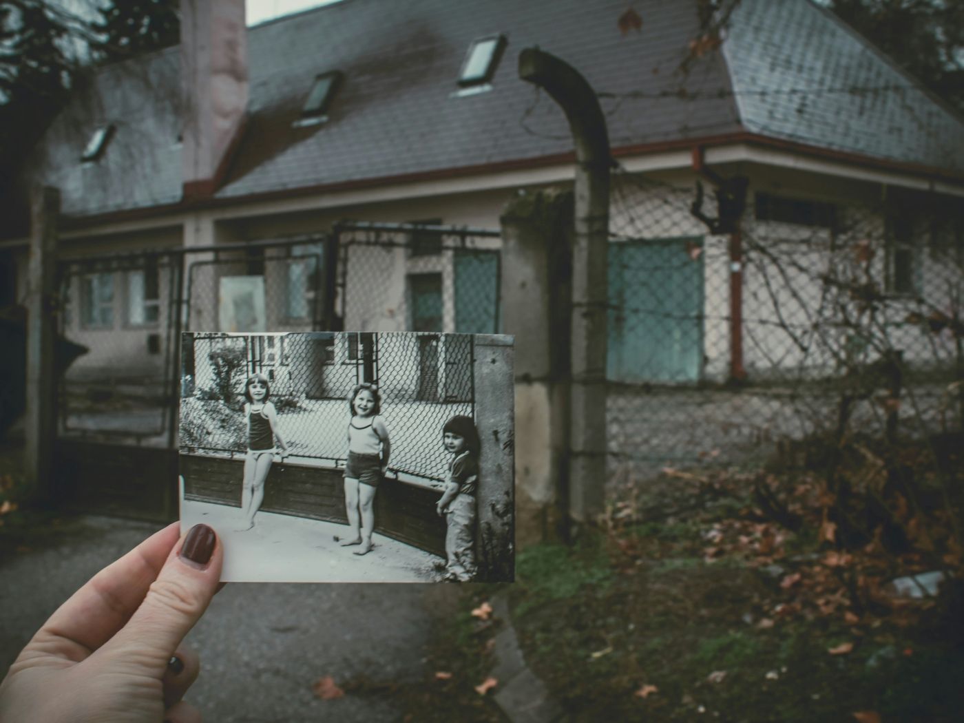 A photo held up to show the present-day location