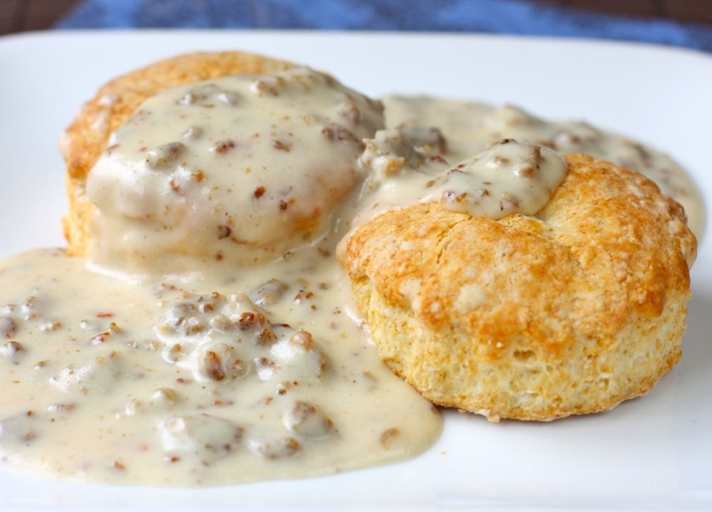 a plate of biscuits and sausage gravy
