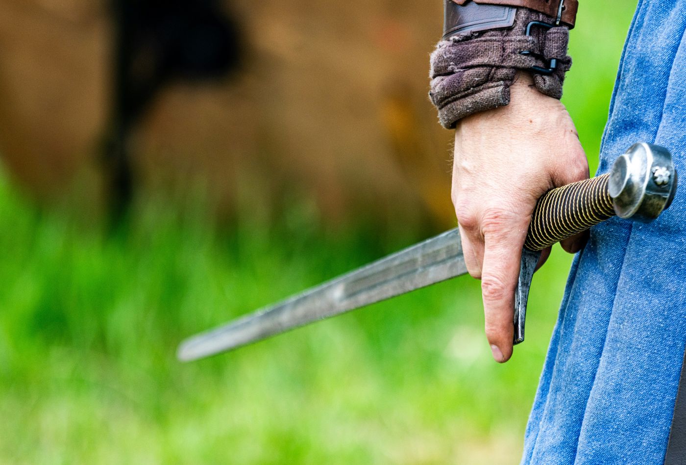 a man's hand holding a sword