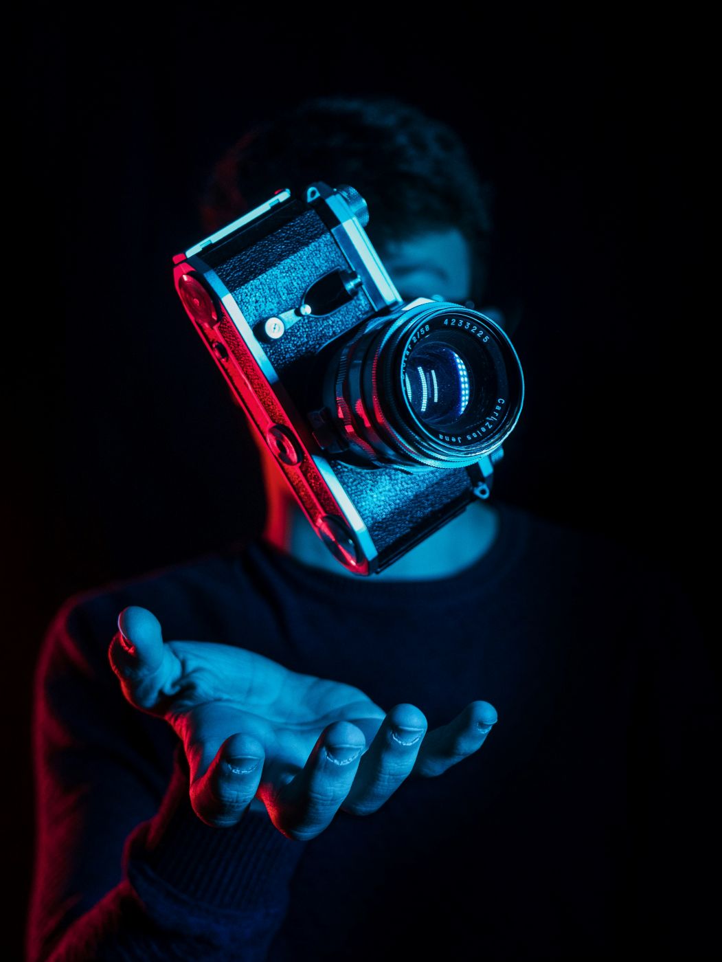 hand tossing a camera in the air