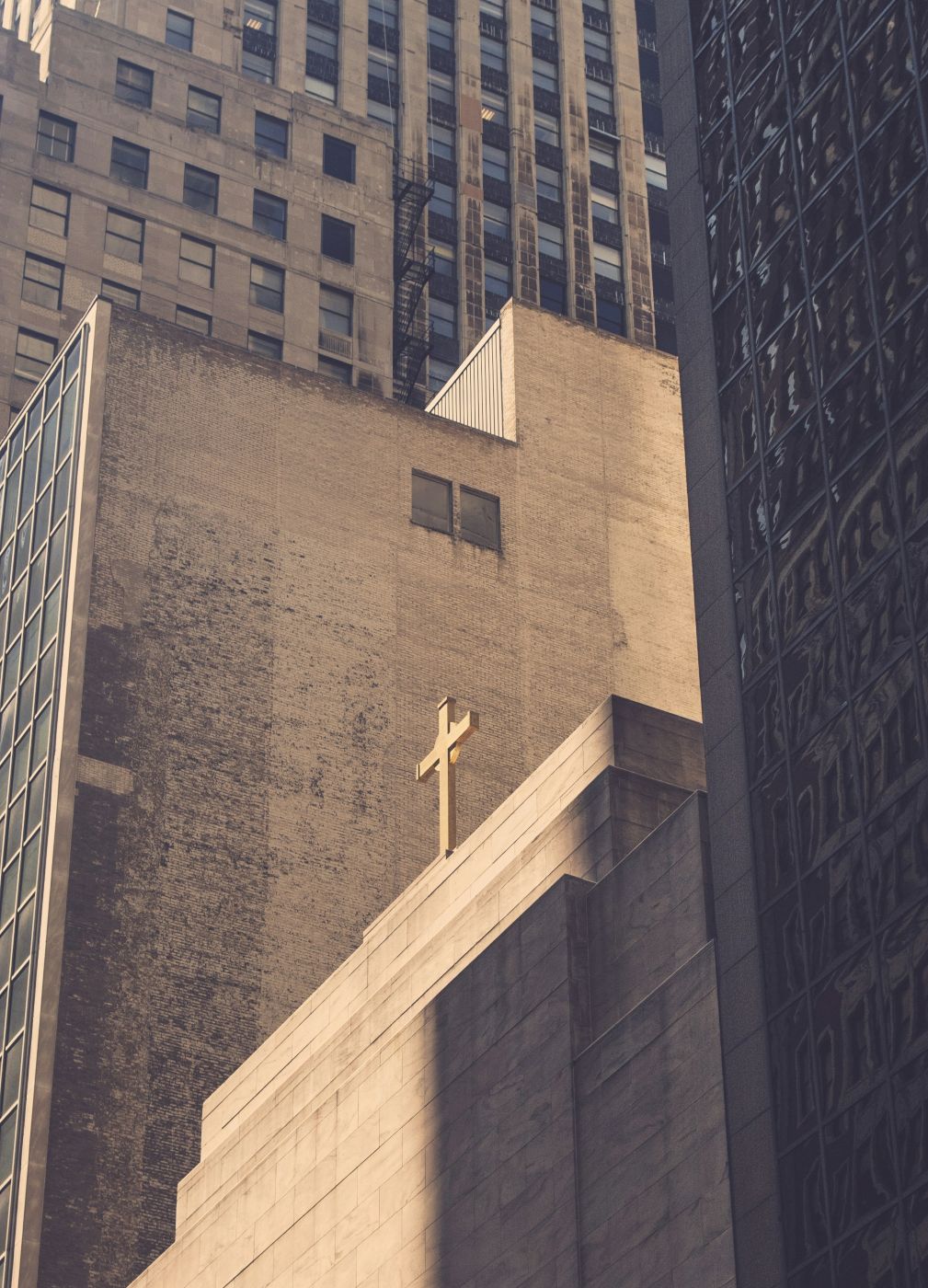 a city block with a cross on top of a building